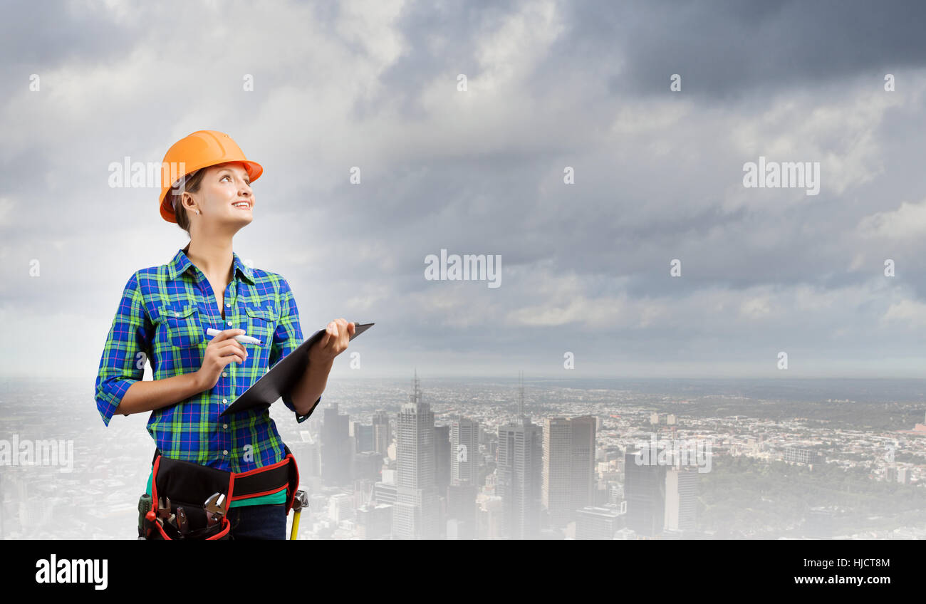 Attractive woman engineer making some notes and sketches hi-res stock ...
