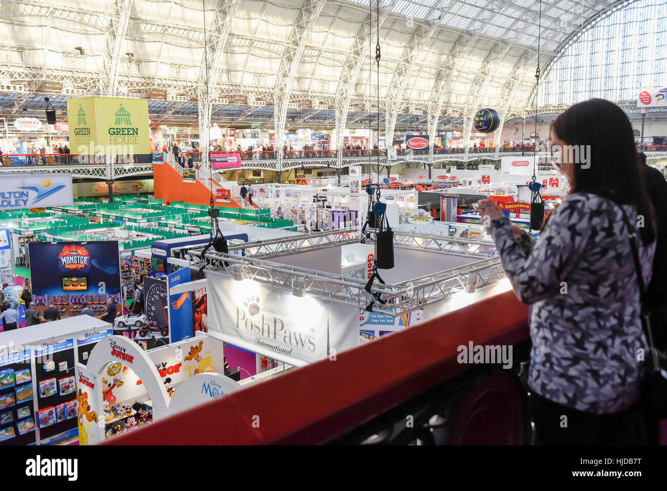 London, UK. 24th Jan, 2017. A vistor looks down at the stands at the opening day of the Toy Fair 2017, taking place at Kensington Olympia. The trade show brings together many of the leading toy manufacturers and distributors and offers a chance for buyers to see the latest toys in preparation for Christmas. Credit: Stephen Chung/Alamy Live News Stock Photo