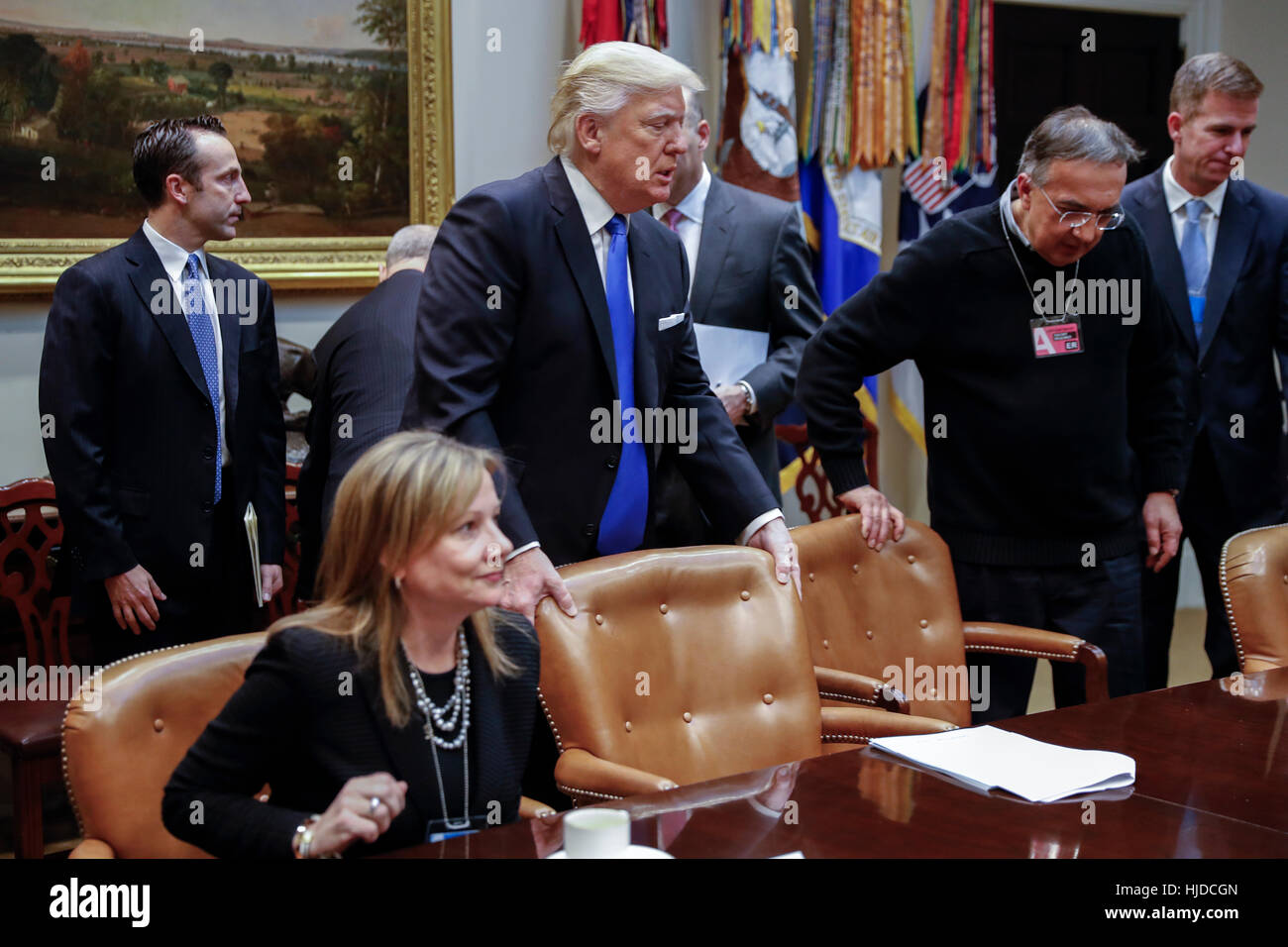 Washington, USA. 24th Jan, 2017. US President Donald Trump (C), with CEO of General Motors Mary Barra (L) and CEO of Fiat Chrysler Automobiles Sergio Marchionne (2R), arrives for a meeting with automobile industry leaders in the Roosevelt Room of the White House in Washington, DC, USA. Credit: Shawn Thew/Pool via CNP /MediaPunch/Alamy Live News Stock Photo