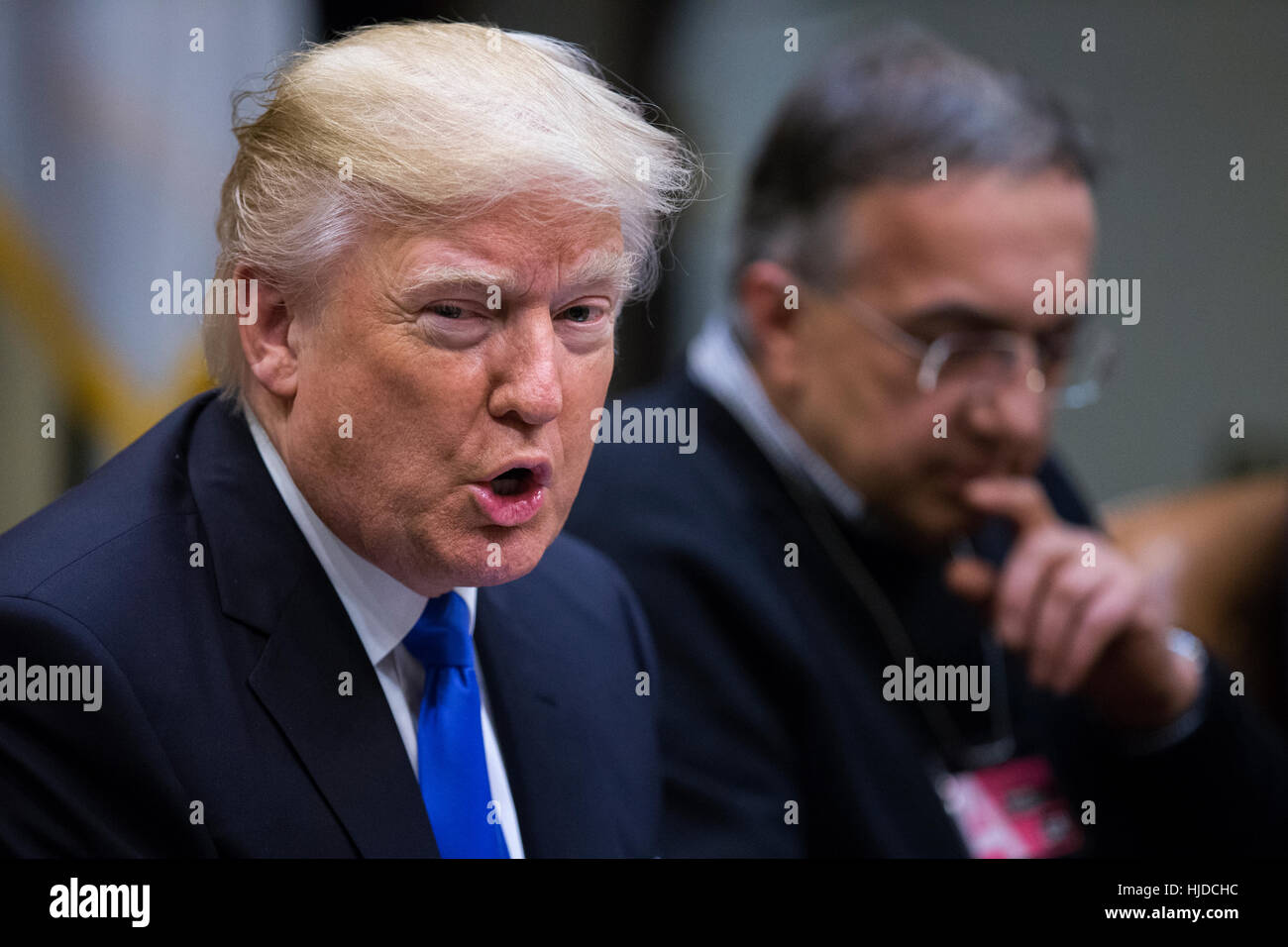 Washington, USA. 24th Jan, 2017. US President Donald Trump (L), with CEO of Fiat Chrysler Automobiles Sergio Marchionne (R), delivers remarks to automobile industry leaders during a meeting in the Roosevelt Room of the White House in Washington, DC, USA. Credit: Shawn Thew/Pool via CNP /MediaPunch/Alamy Live News Stock Photo