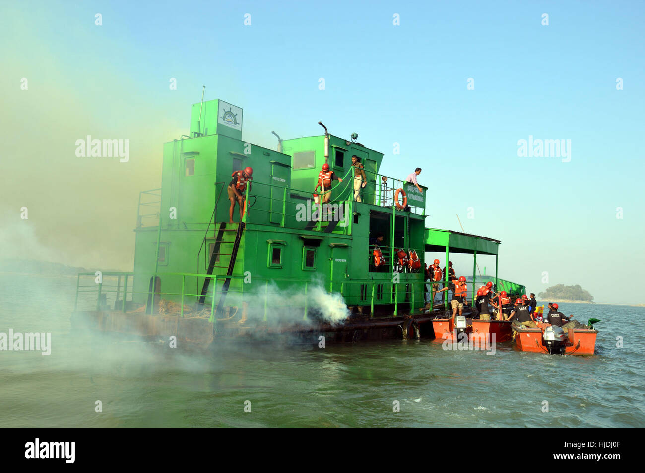 Guwahati, India. 25th January 2017. SDRF and Fire emergency service personnel performing Mock Drill demonstration of Fire Fighting and Rescue in a Burning Ship at the heart of river Brahmaputra in Guwahati on 25-01-17. Credit: Abhijit Bose/Alamy Live News Stock Photo