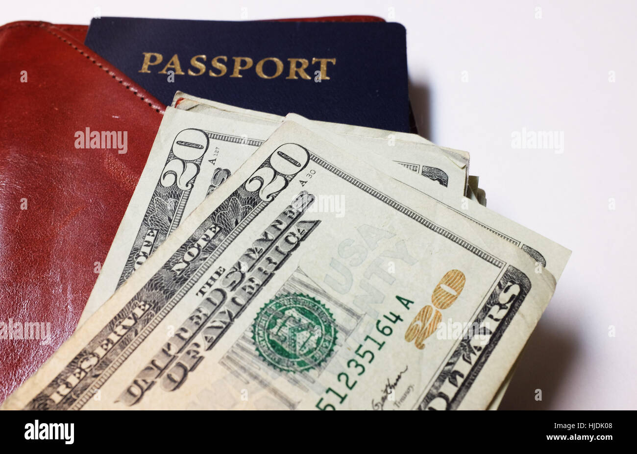 Passport, travel wallet, and United States twenty dollar bills. Stock Photo