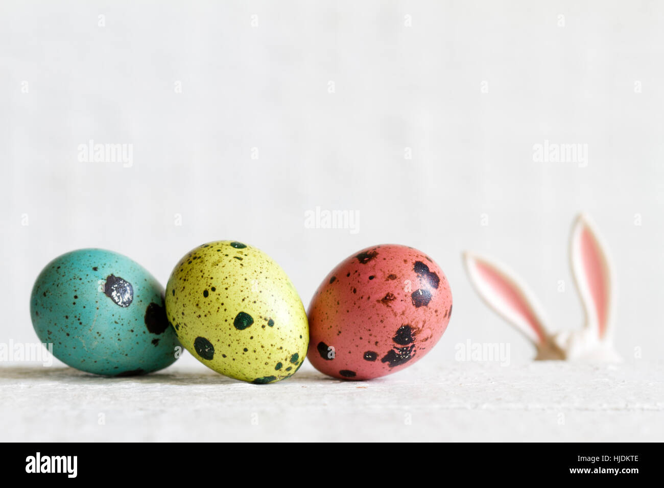 Easter eggs and bunny ears abstract background on white boards Stock