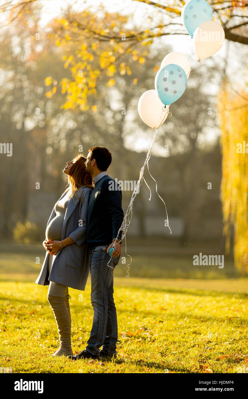 Happy loving couple with balloons in the park Stock Photo - Alamy