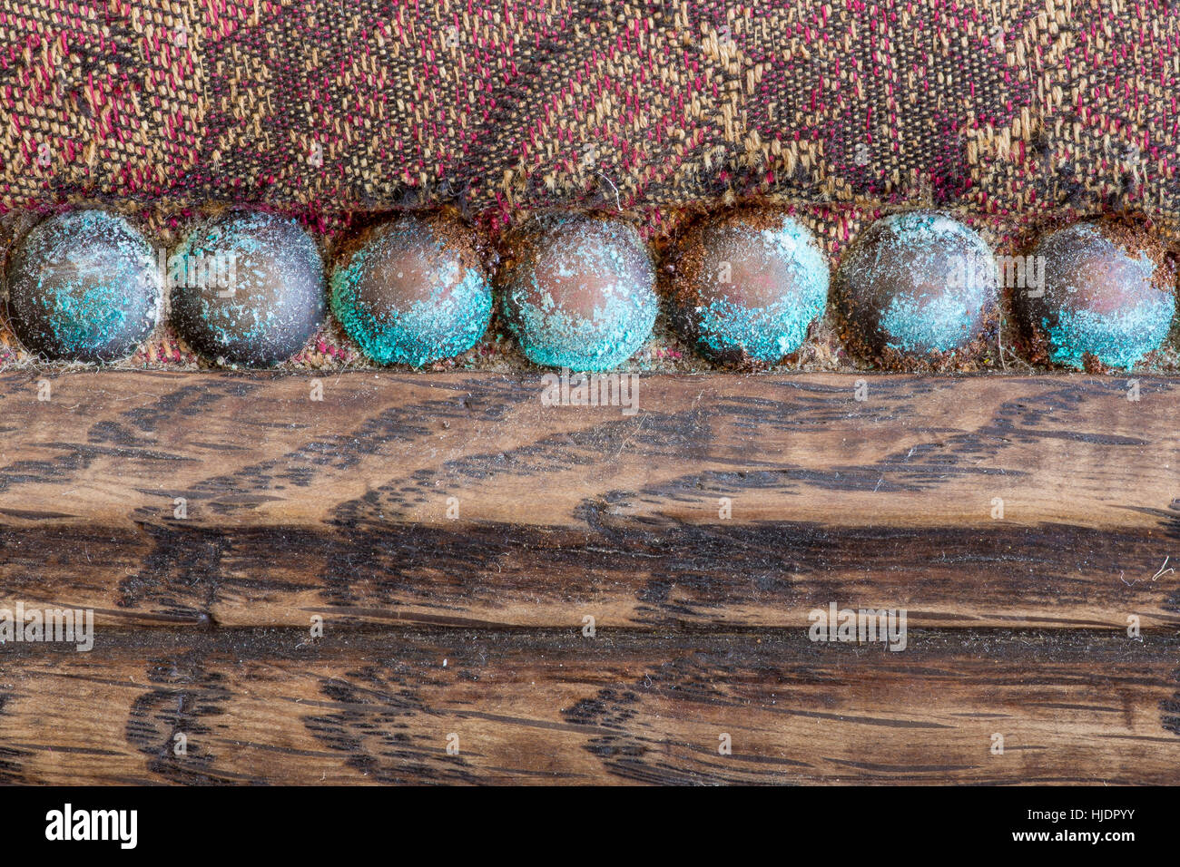 Turquoise blue patina on old copper upholstery nails studs on antique oak  chair seat antiques restoration work in workshop with worn vintage fabric  Stock Photo - Alamy