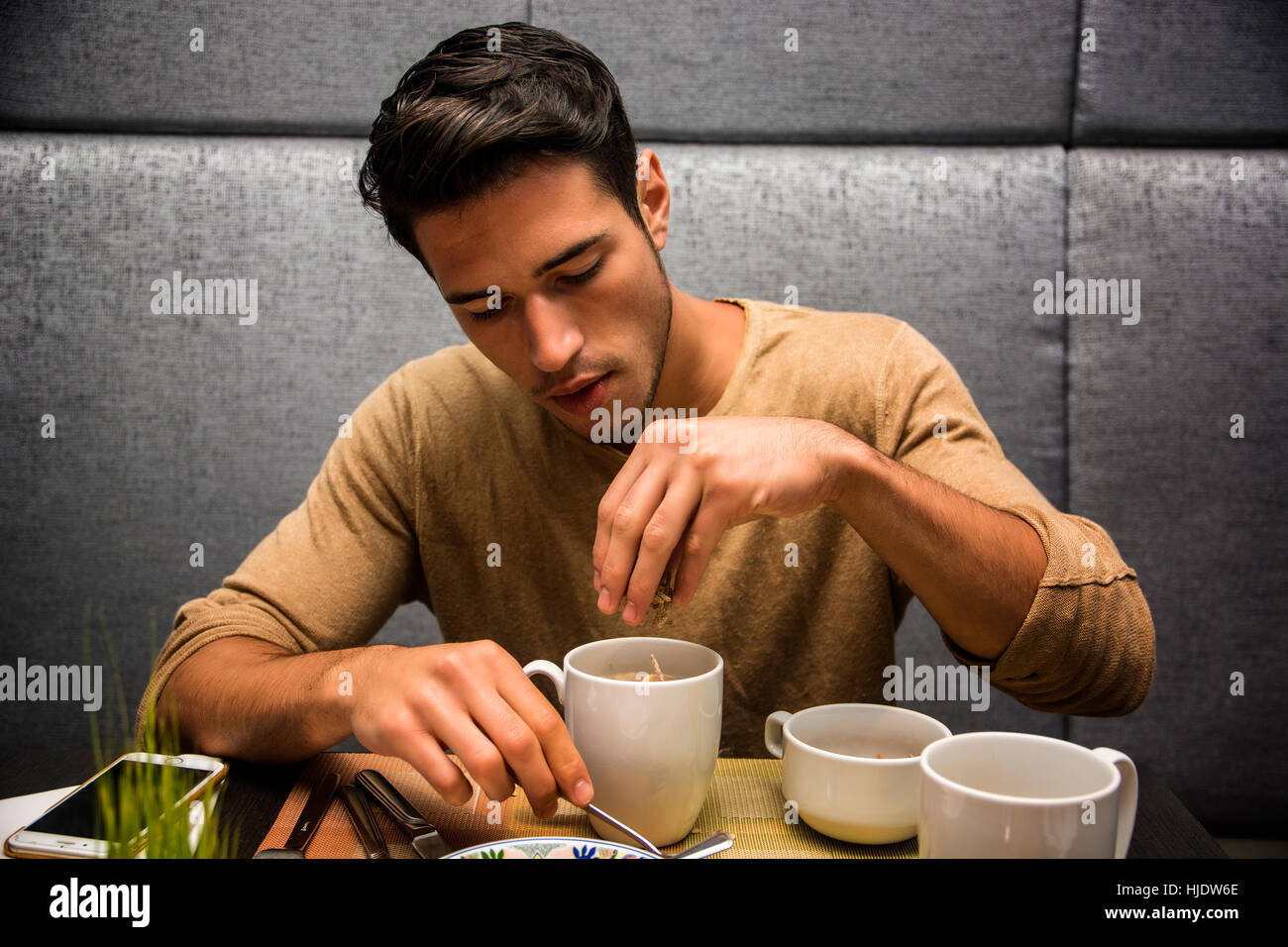 Attractive Young Man Eating Breakfast Stock Photo