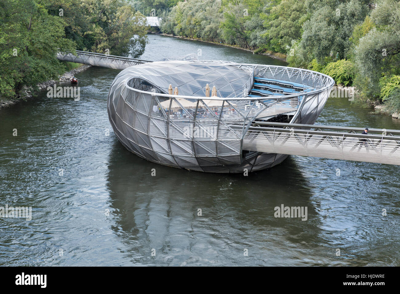 GRAZ, AUSTRIA - SEPTEMBER 11, 2015: People visit Insel Cafe on the artificial island Murinsel on the Mur river, designed by American architect Vito Ac Stock Photo