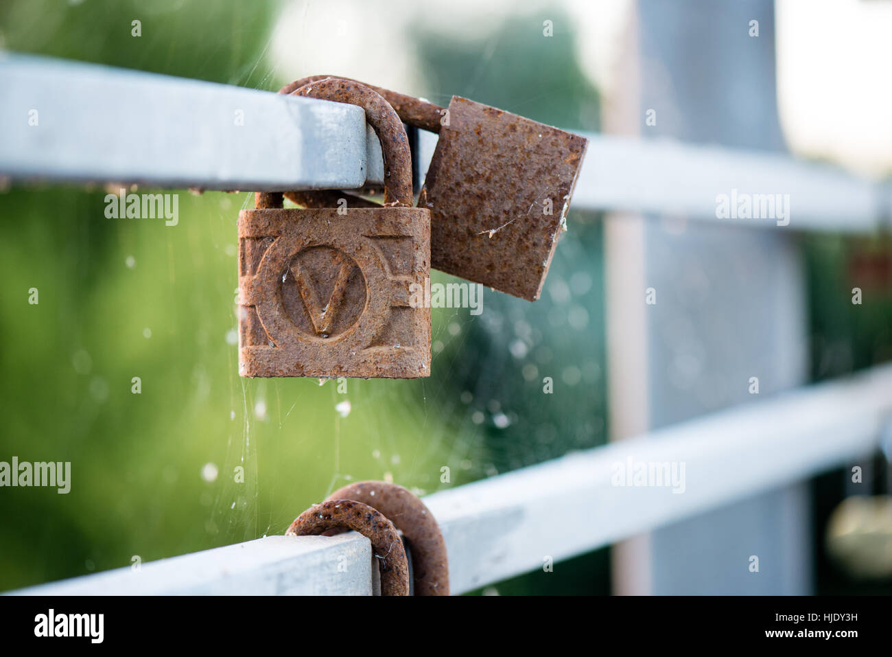 rusty metal locks on the bridge with blur background Stock Photo - Alamy