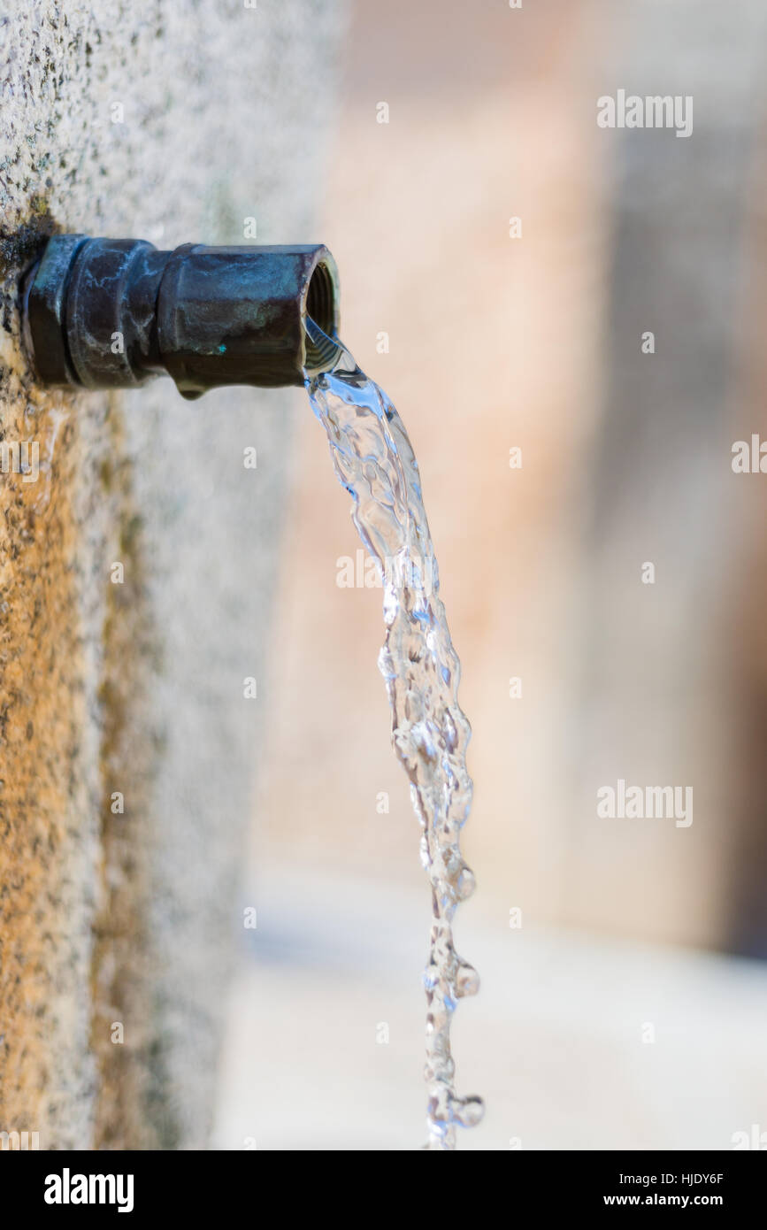 Water tap with water drop outdoor park background Stock Photo - Alamy