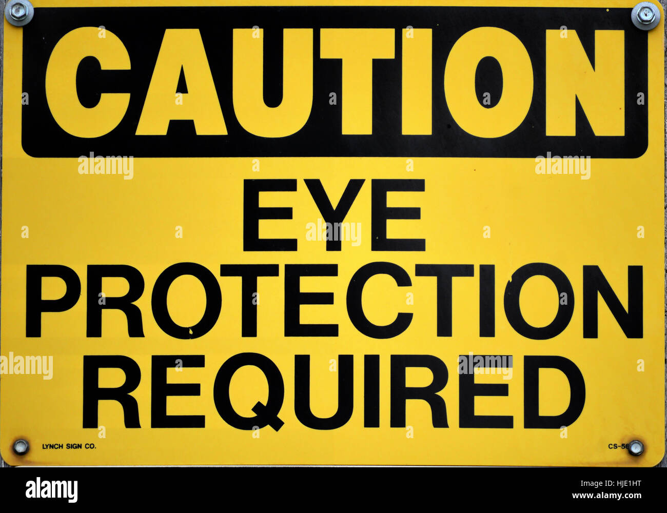 A yellow eye protection required sign. Stock Photo