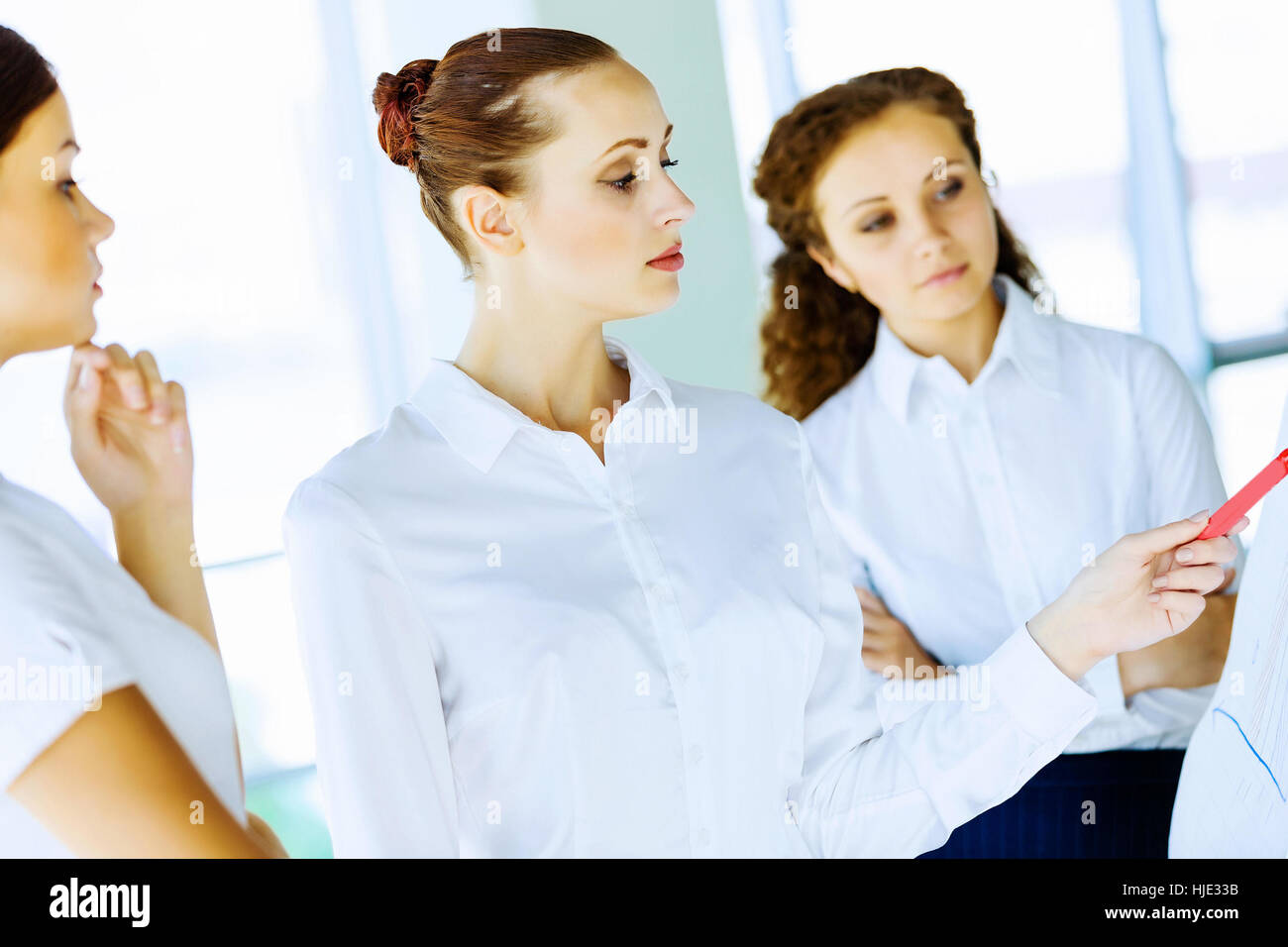 Image of three young businesswomen at meeting Stock Photo - Alamy