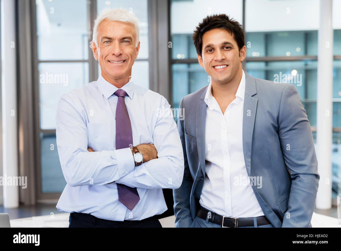 Two businessmen in office standing Stock Photo - Alamy