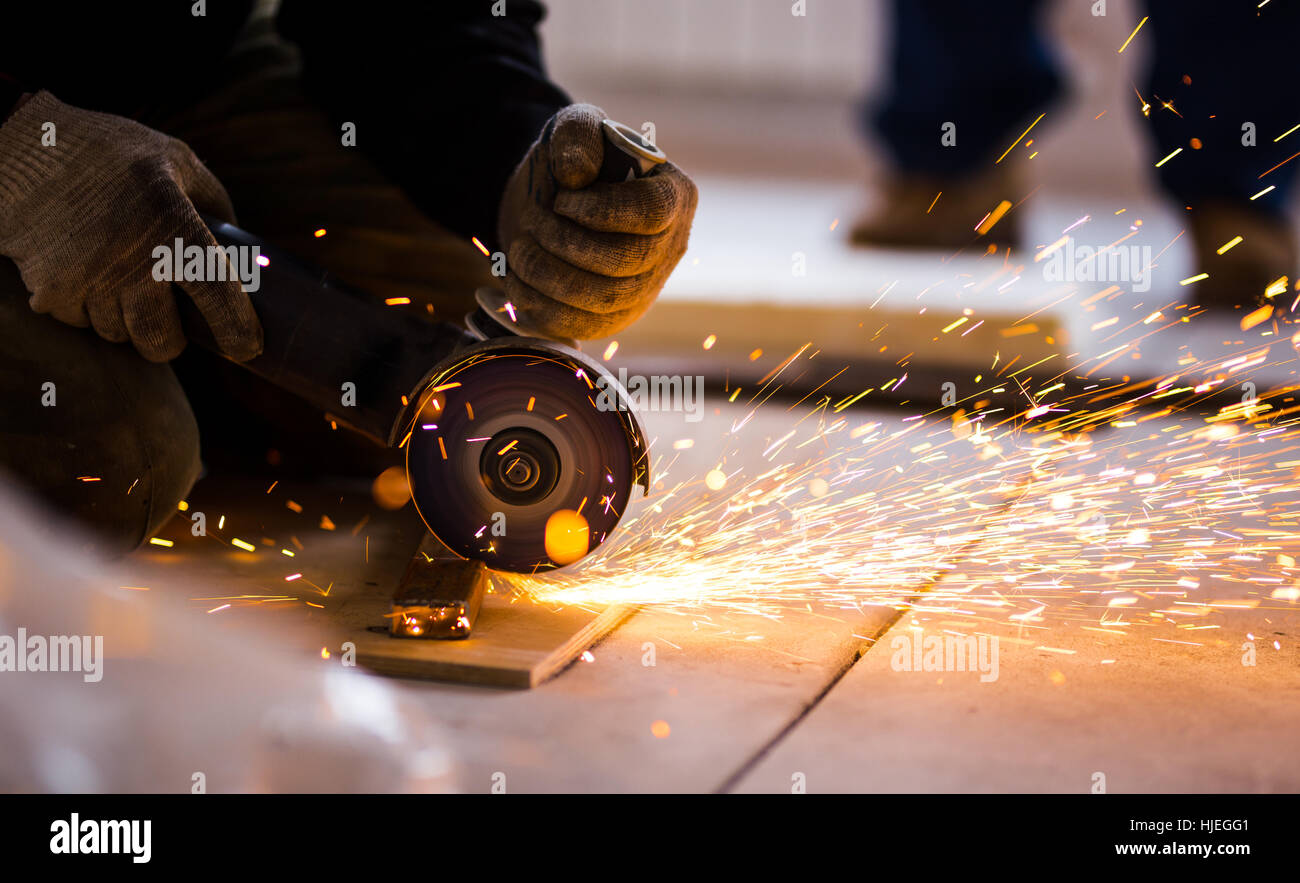 Cutting metal with angle grinder. Stock Photo