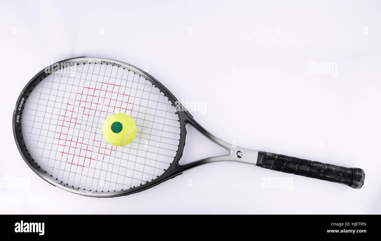 Tennis racket with ball cut out isolated on white background Stock Photo
