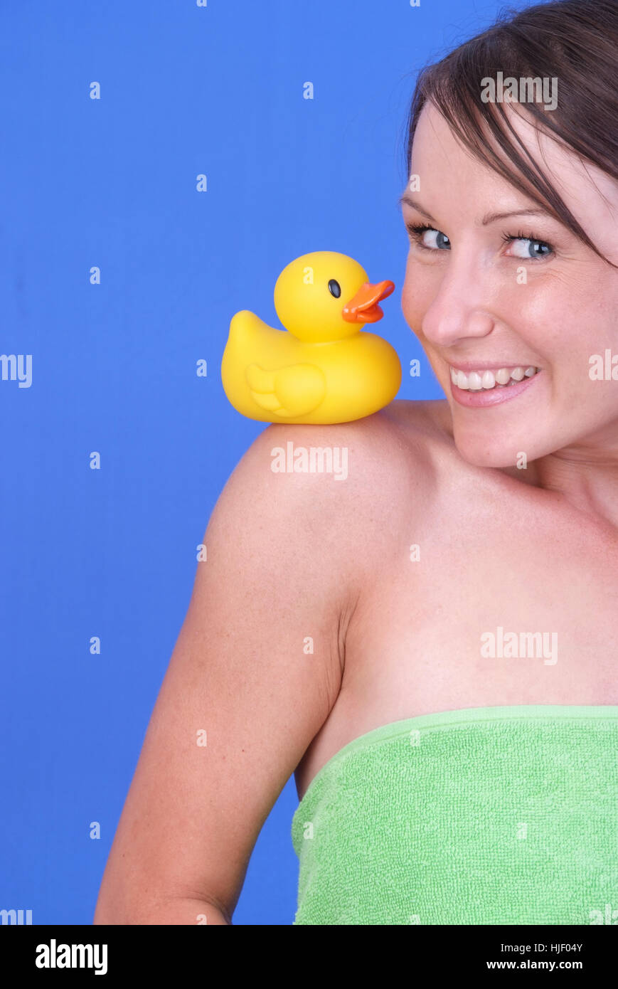 Woman with rubber duck on shoulder Stock Photo