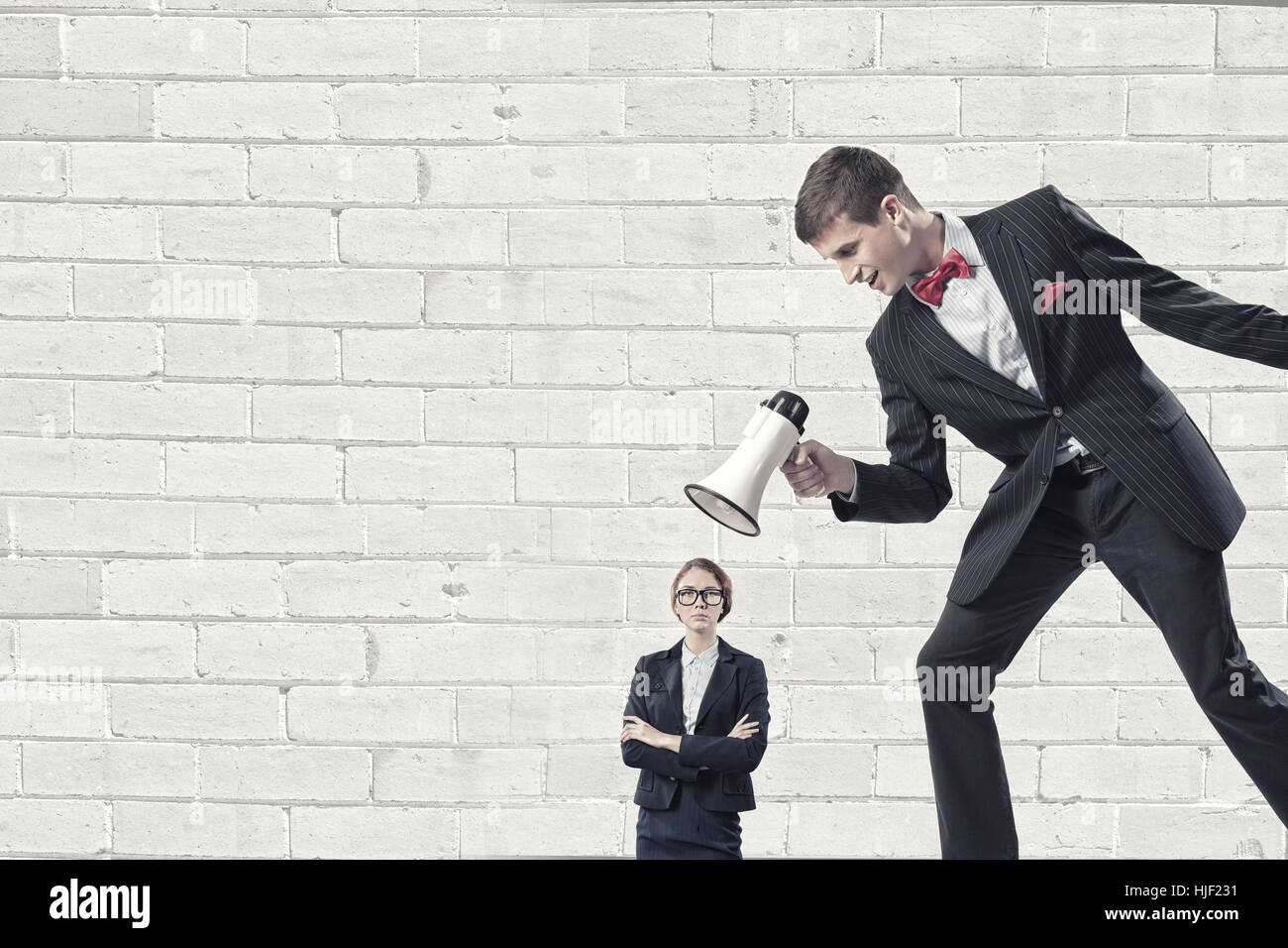 Aggressive businessman screaming in megaphone on her colleague Stock ...