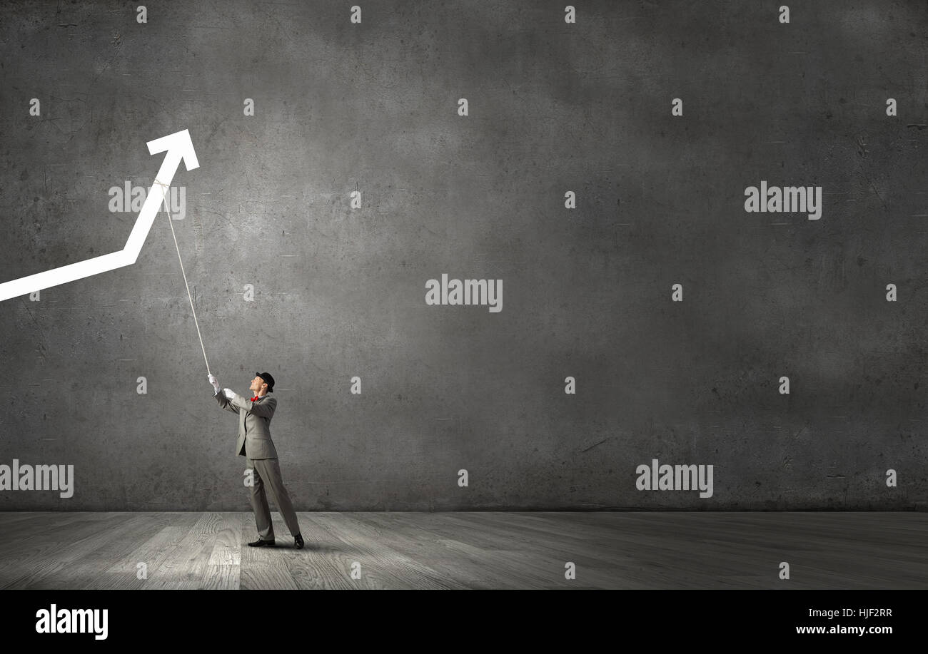 Businessman pulling arrow with rope and making it raise up Stock Photo ...