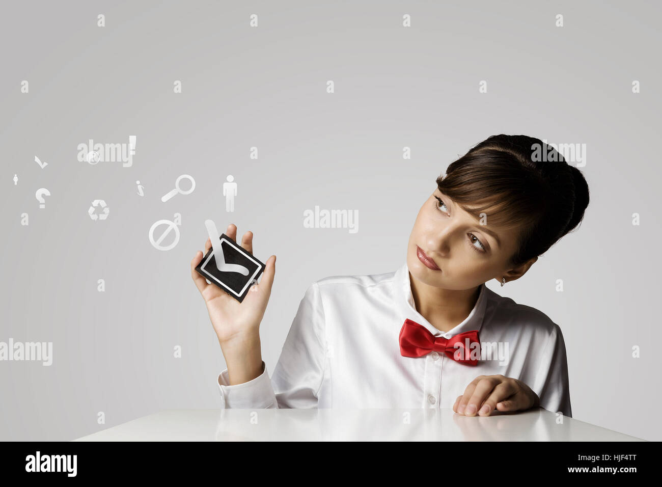 Young woman holding black card with tick Stock Photo