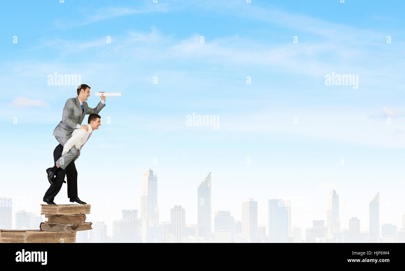 Businessman riding on back of his colleague Stock Photo - Alamy