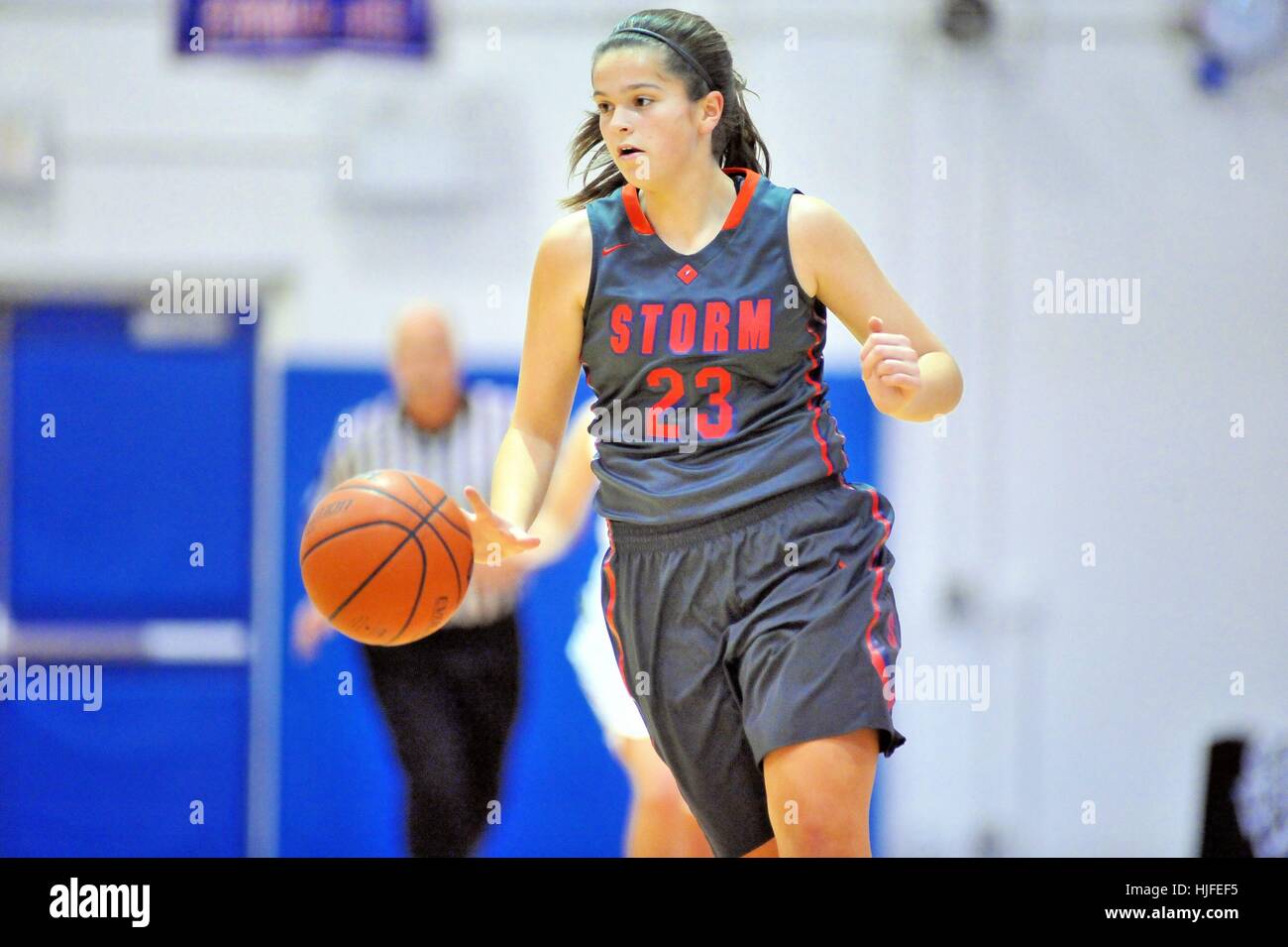 Player bringing the ball up court while crossing midcourt during a