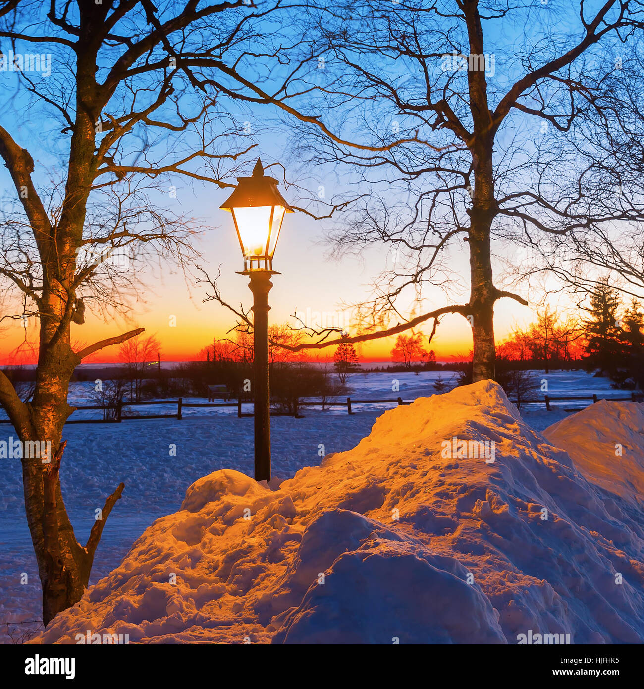 illuminated old street lamp in winter landscape at night Stock Photo ...