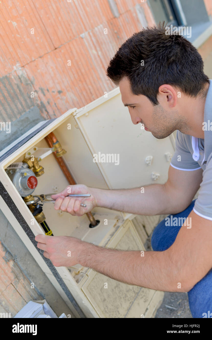 Fixing the water meter Stock Photo Alamy