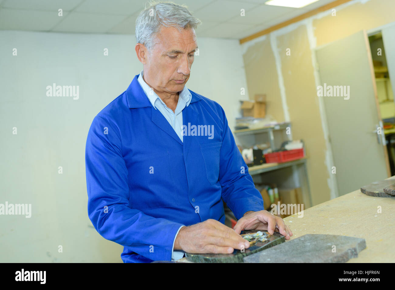 stonemason engraving memorial stone for grave Stock Photo Alamy