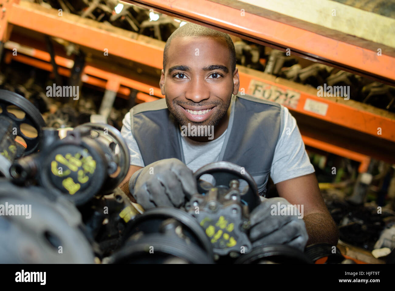 Portrait of man amongst second hand car parts Stock Photo Alamy