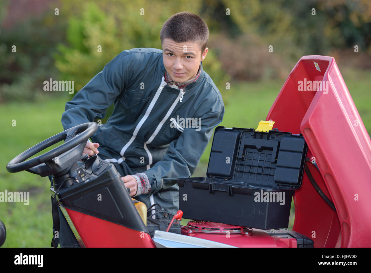 fixing an expensive lawn mower Stock Photo - Alamy