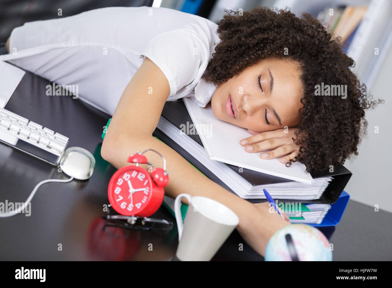 tired young business woman is sleeping on workplace Stock Photo - Alamy