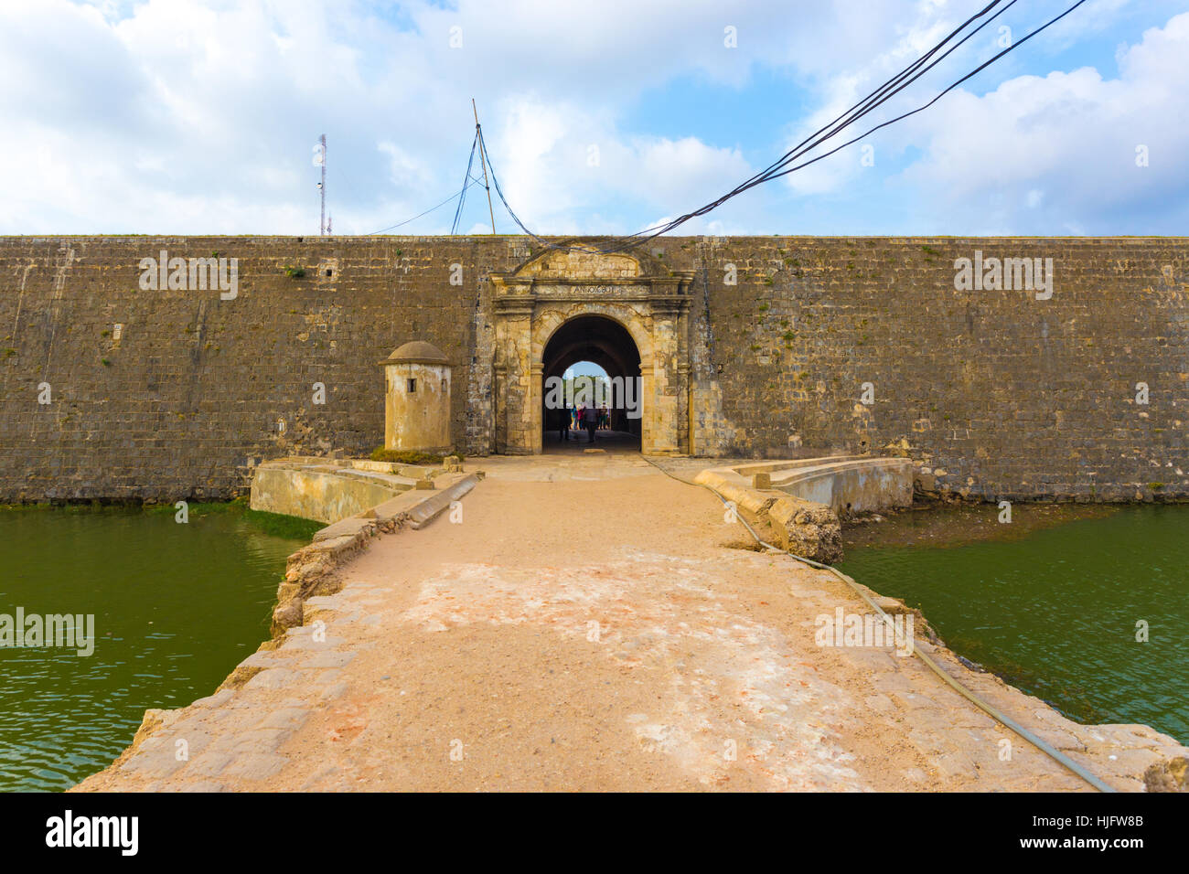 Bridge over watery moat leads to portal door entrance of Jaffna Fort in Sri Lanka. Horizontal Stock Photo