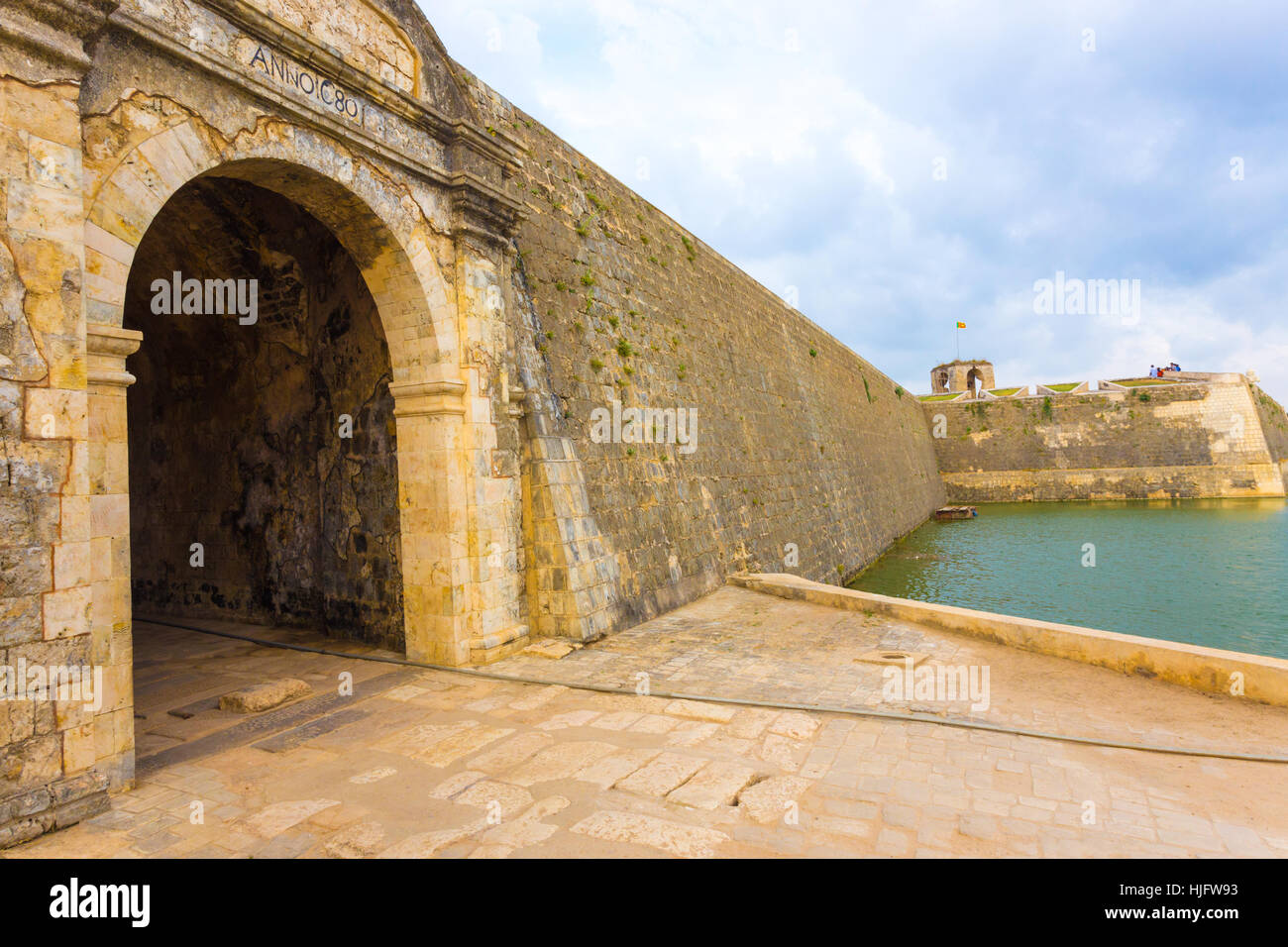 Jaffna Fort entrance and wall bordered by watery moat in Sri Lanka. Angled Stock Photo