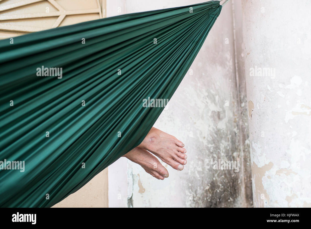 Man's feet protruding from his hammock, Saigon Stock Photo