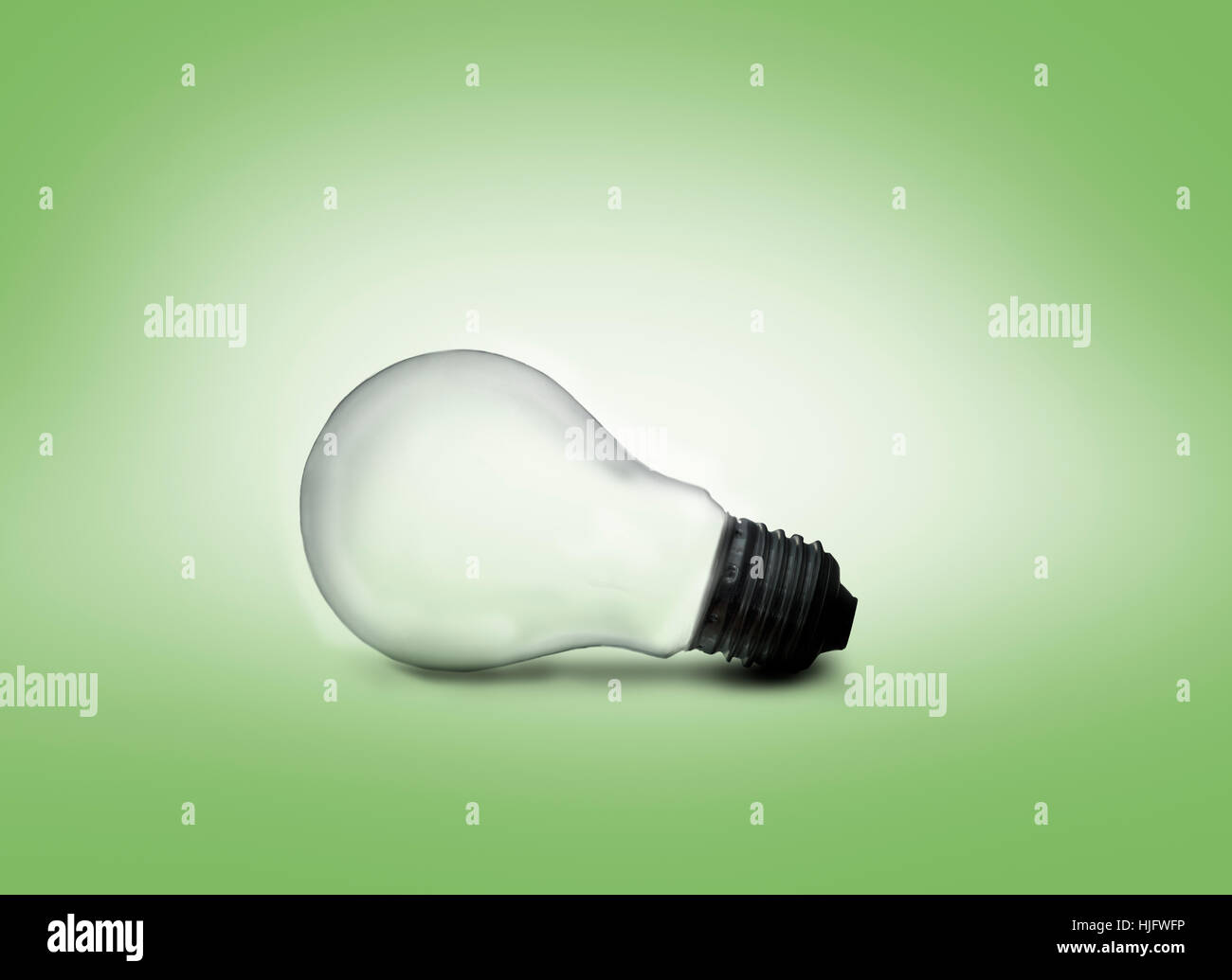 A light bulb against green background Stock Photo - Alamy