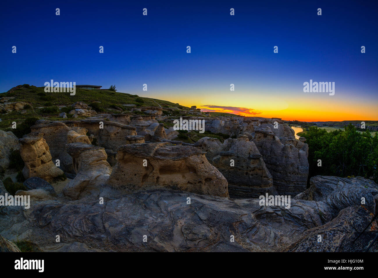 Sunrise over the Hoodoo badlands at Writing on Stone Provincial Park and Áísínai'pi National Historic Site in Alberta, Canada. Stock Photo