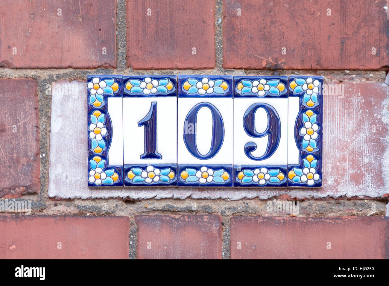House number 109 sign on colourful flowery ceramic tiles Stock Photo