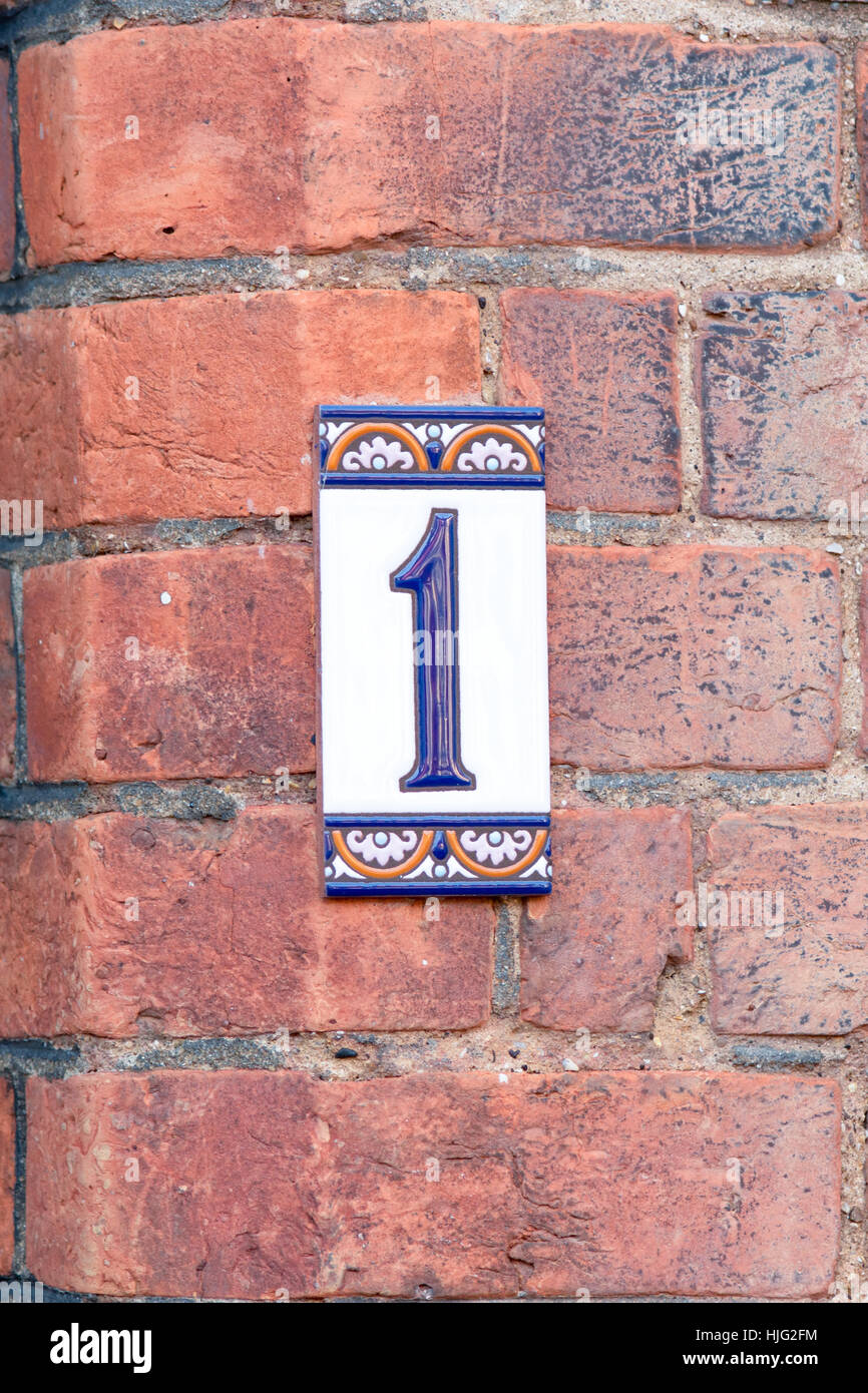 House number 1 sign ceramic tile on wall Stock Photo