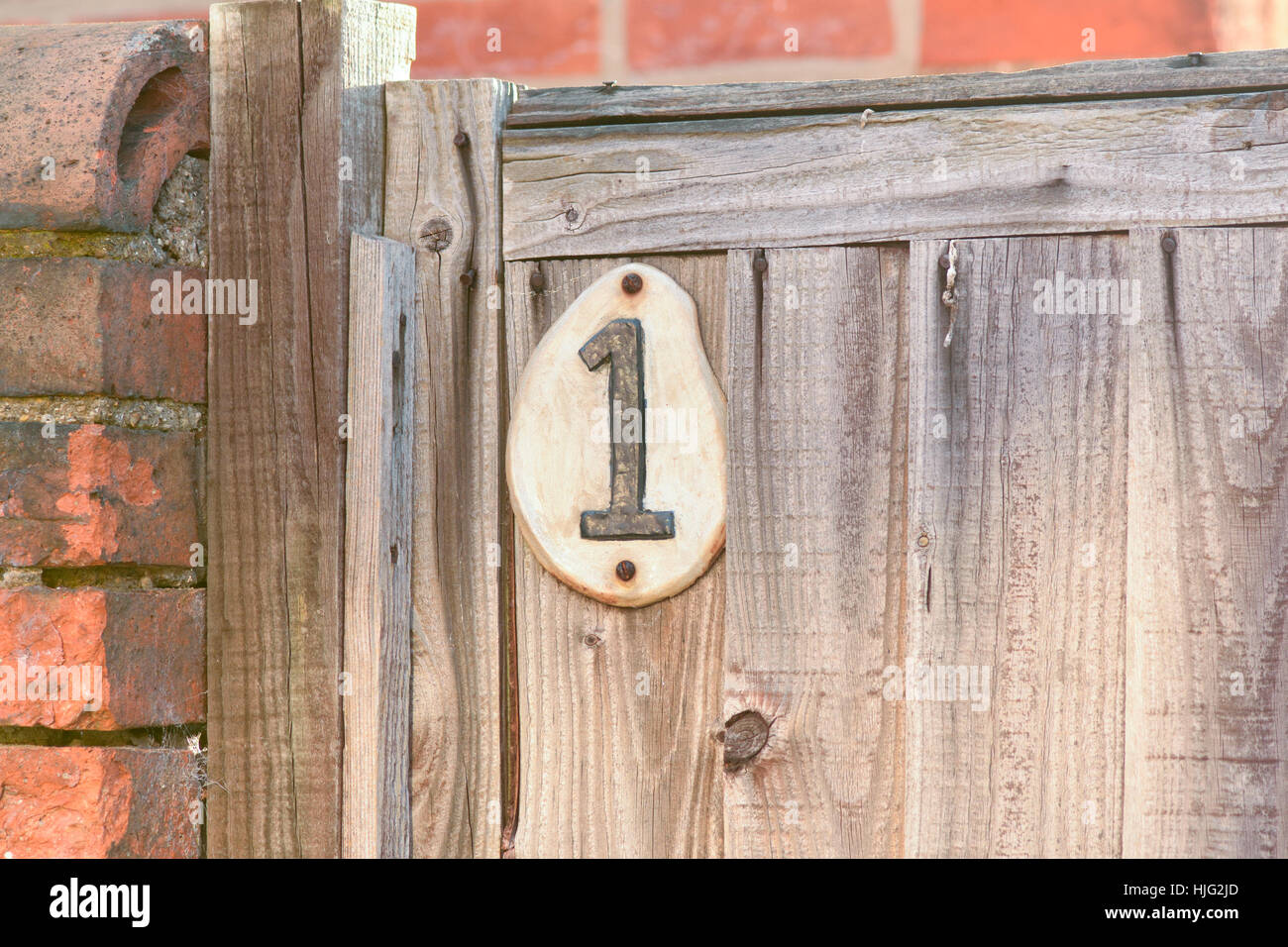 House number 1 sign on wooden gate Stock Photo Alamy