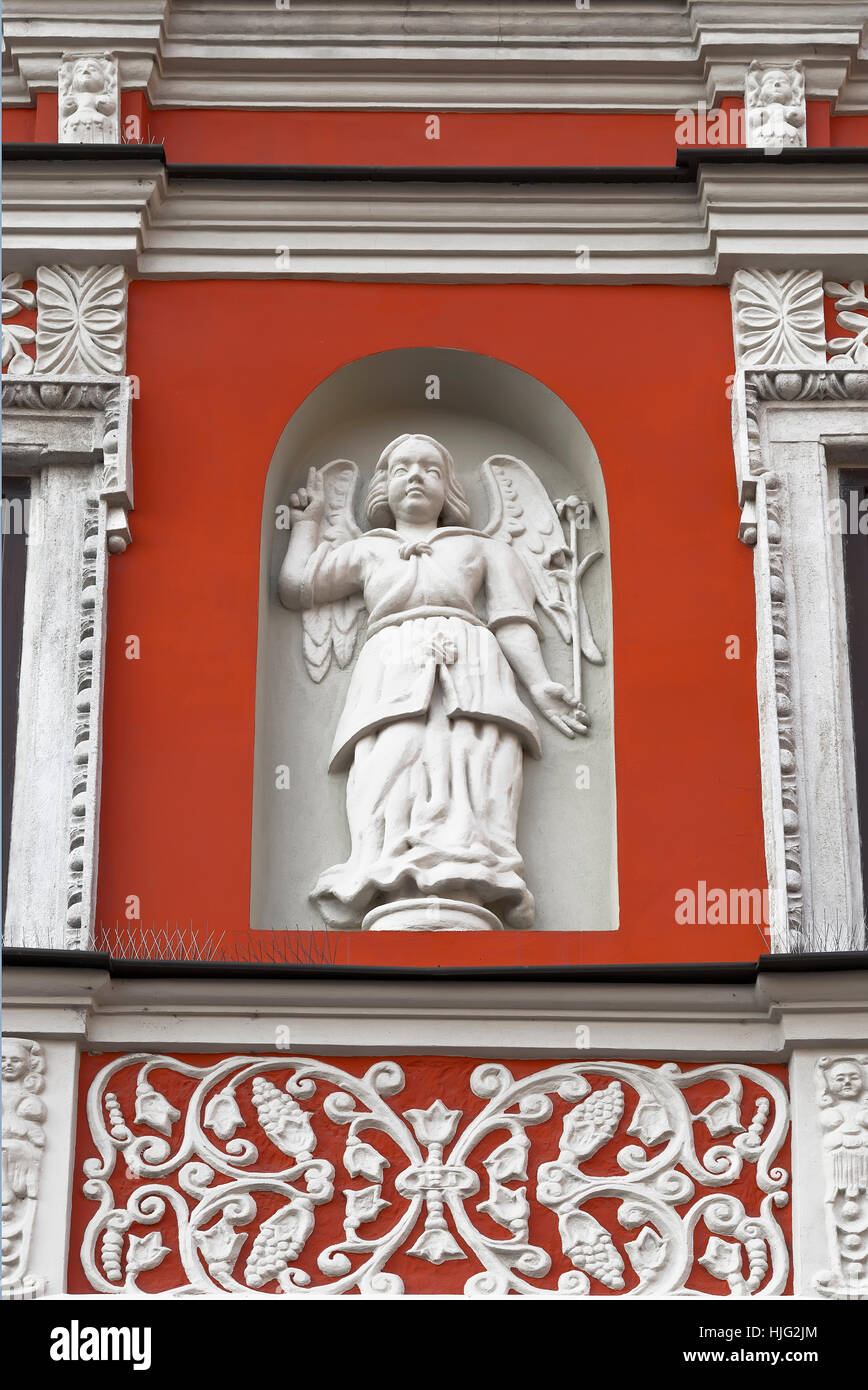 Fragment of a wall of an old house with sculpture of an angel in a niche. Zamosc. Poland Stock Photo