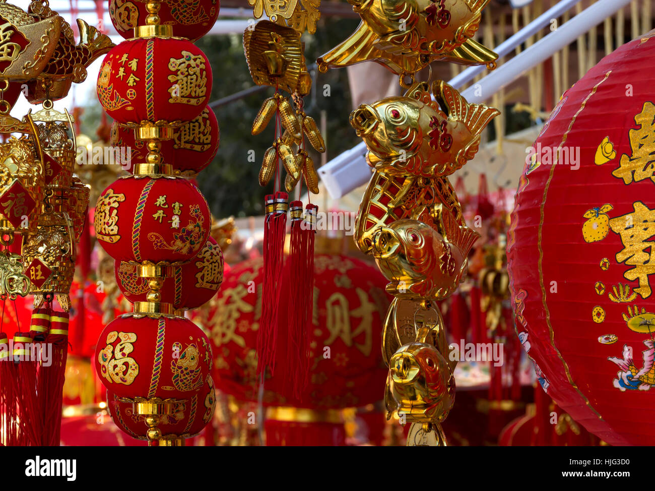 chinese traditional decor for lunar new year red paper lanterns and gold fish close up selective focus Stock Photo