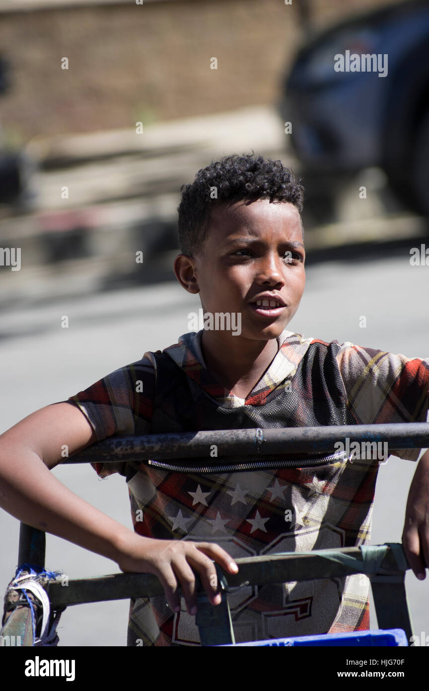 Ethiopian boy on the street hand on a lorry Stock Photo
