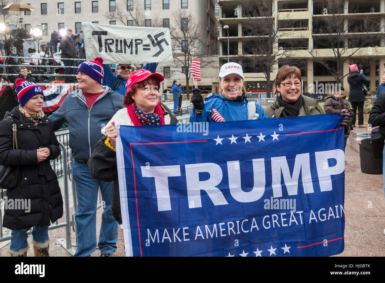 Washington, DC USA - 20 January 2017 - Supporters and a protester on Pennsylvania Avenue during the inauguration of President Donald Trump. Stock Photo