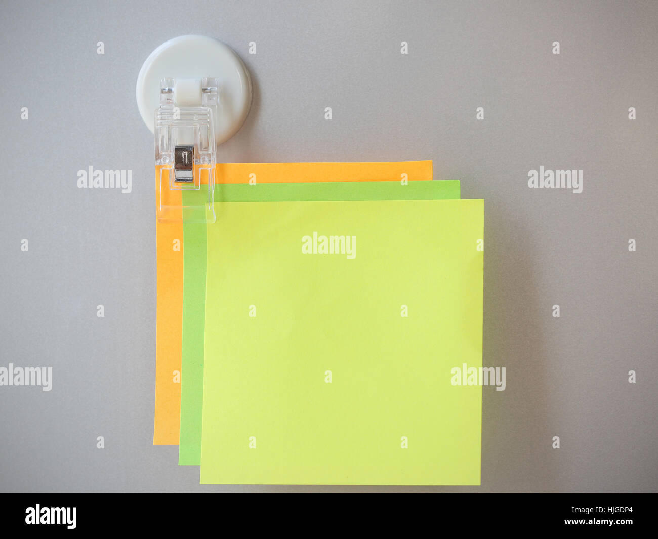 post it clip by clip on gray refrigerator background for input