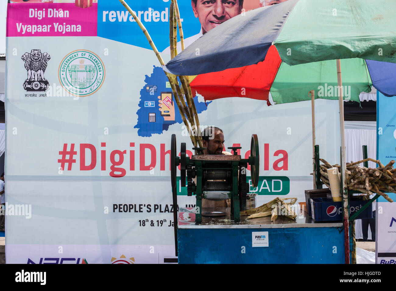 HYDERABAD,INDIA - JAN 19,2017 A Sugarcane juice vendor promotes digital payments by displaying stickers of ewallet at digi dhan mela in the city. Stock Photo