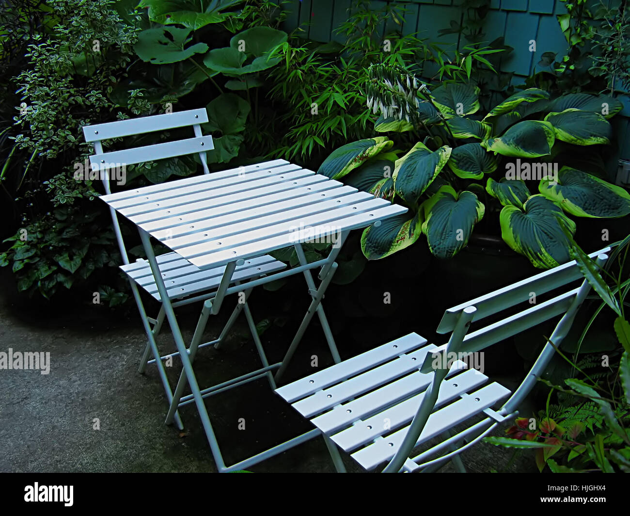 A photograph of a set of table and chairs located in a garden Stock ...