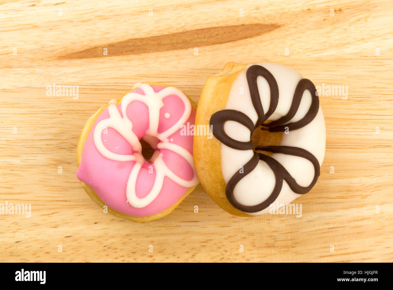 Top view of tasty doughnuts on a wooden board Stock Photo