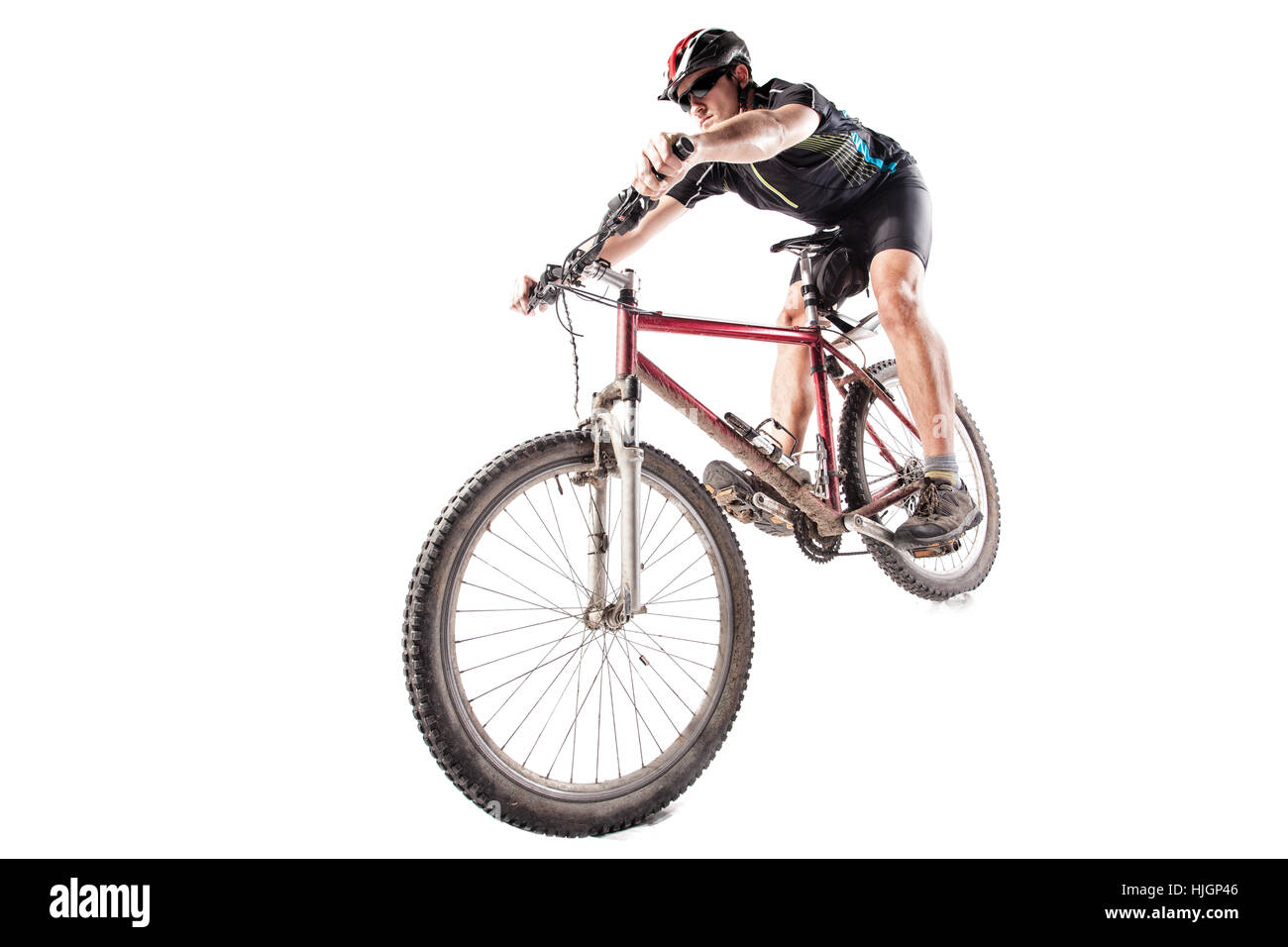 Male bicyclist riding a very dirty mountain bike downhill style Stock Photo