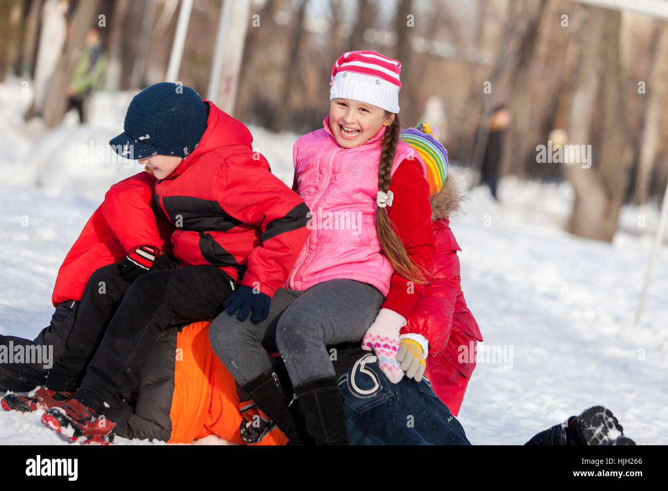 Children in winter park having fun and playing snowballs Stock Photo ...
