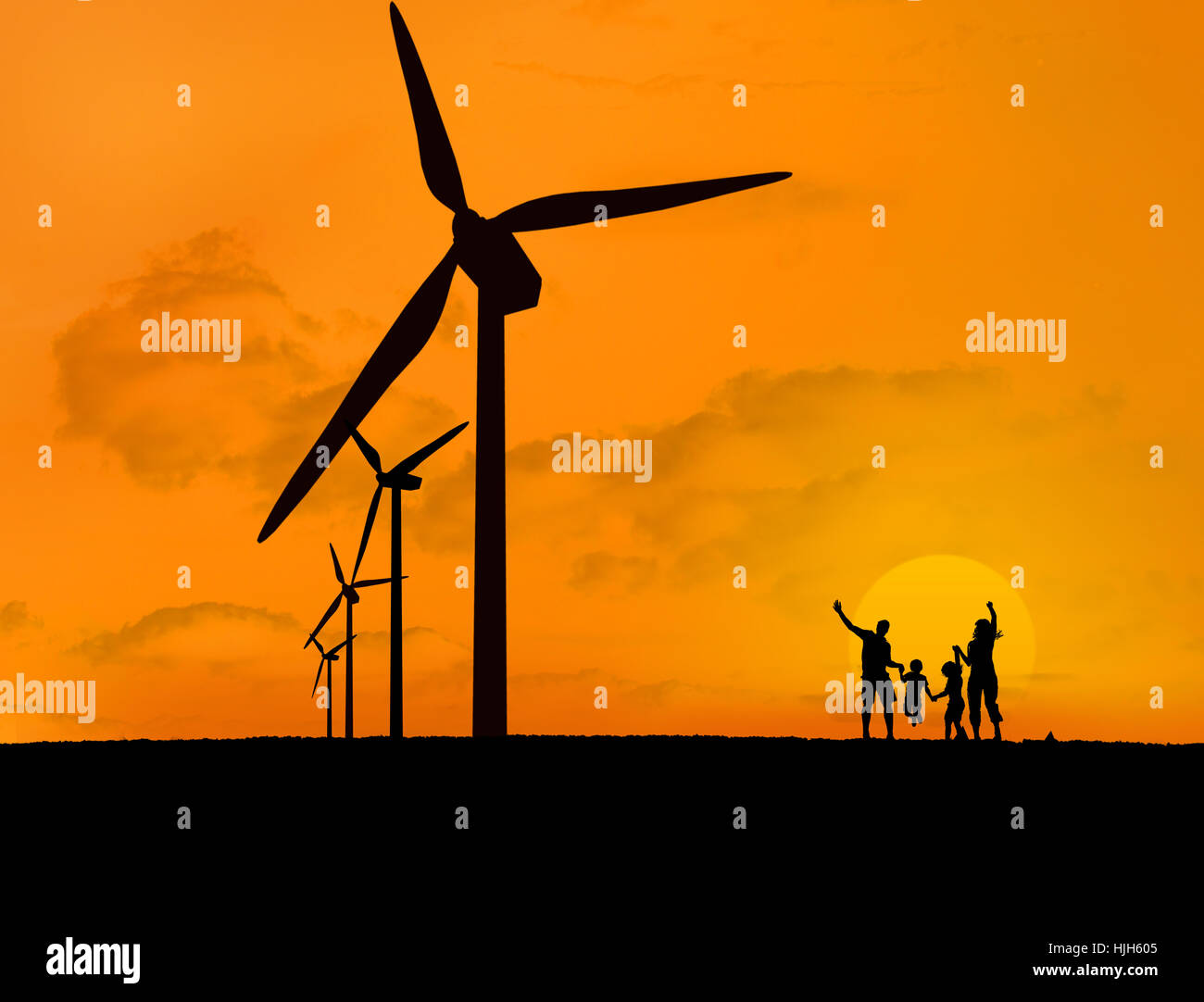 Wind turbines and silhouette of happy family with a sunset Stock Photo ...