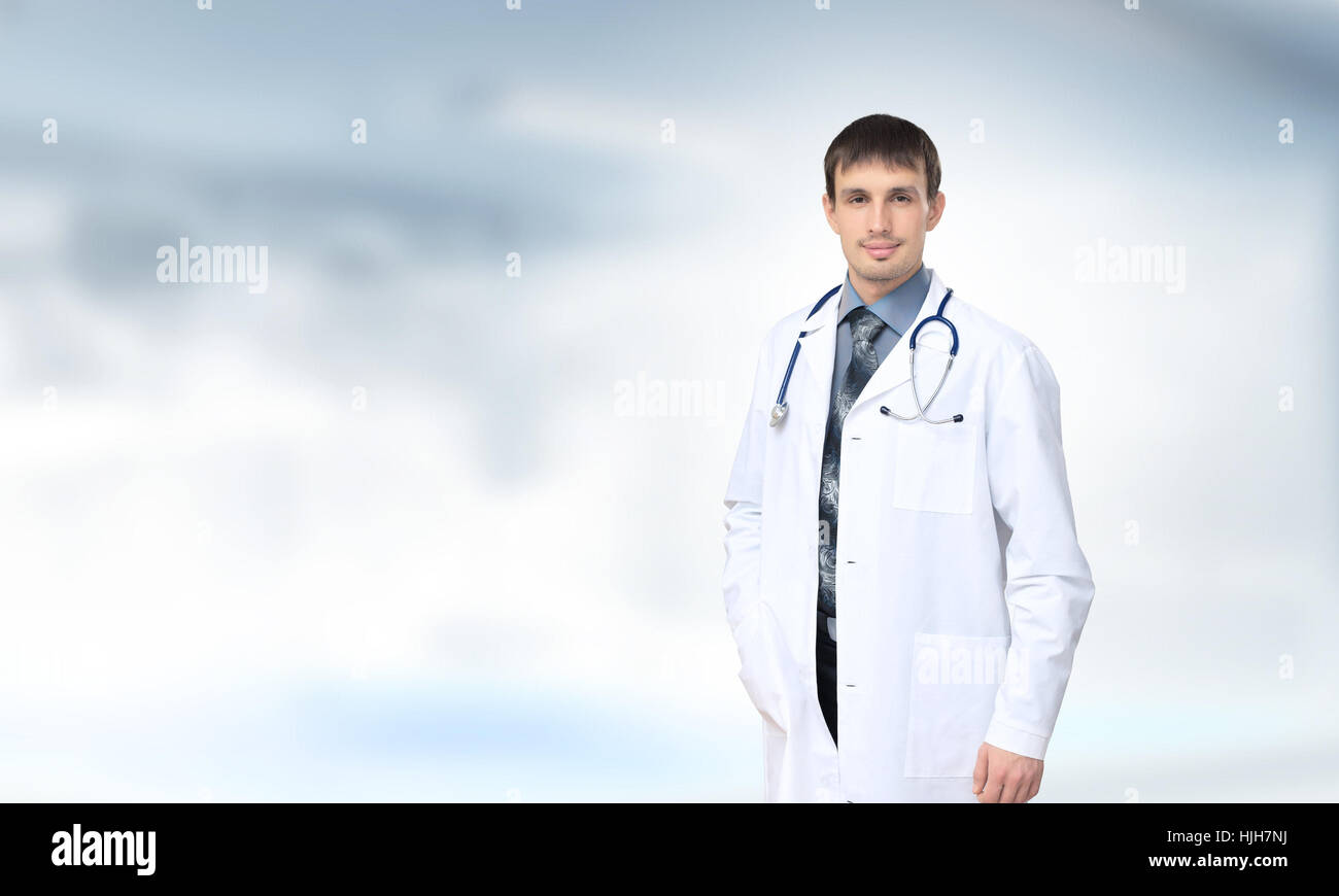 Handsome smiling young doctor hi-res stock photography and images - Alamy